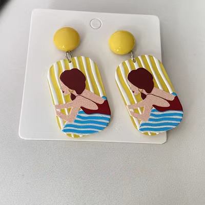 Acrylic earrings with portrait of a girl lying on beach - yellow and blue